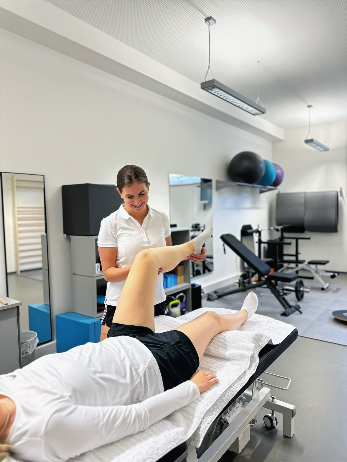 Manuelle Therapie: Physiotherapeutin Carolina Neumayr mobilisiert das Kniegelenk einer Patientin